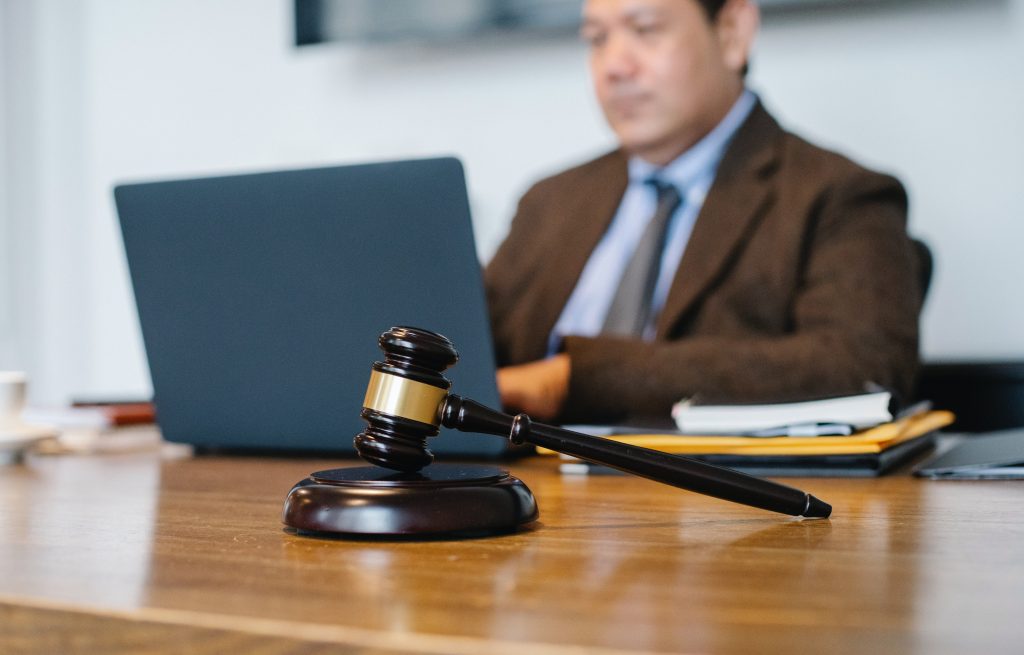 Man at his computer with a gavel