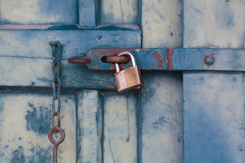 Gold padlock locking door