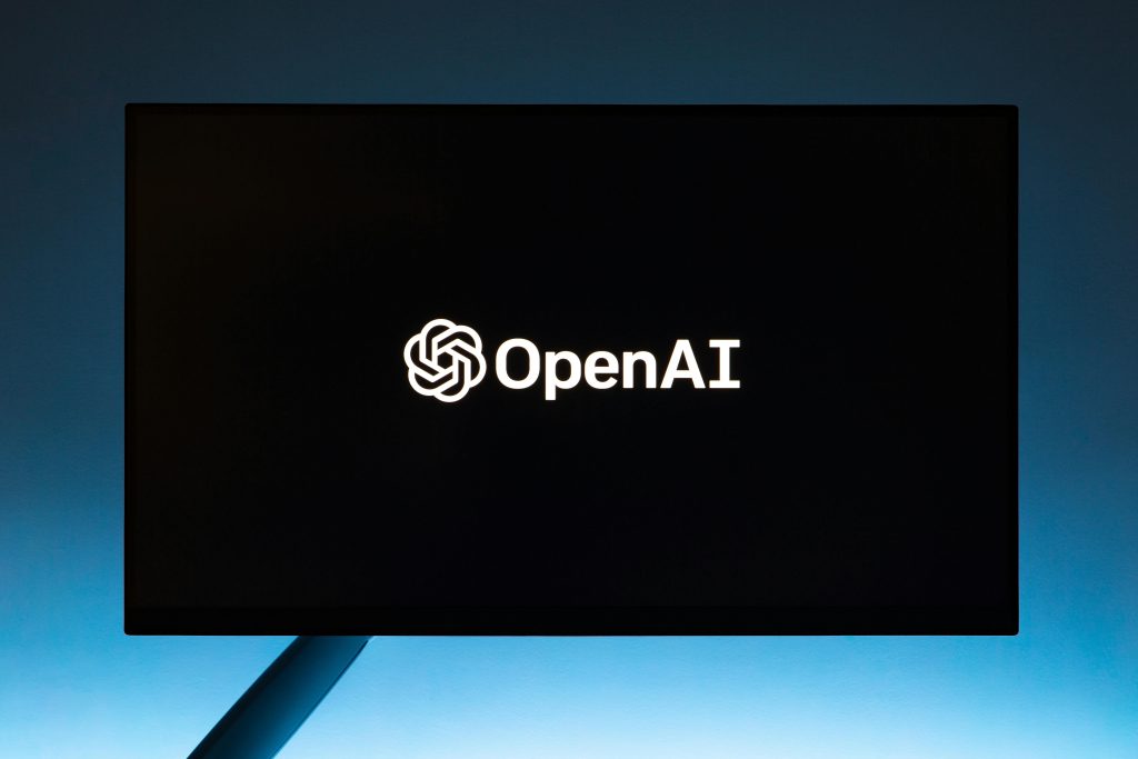 A monitor with the OpenAI logo on the screen