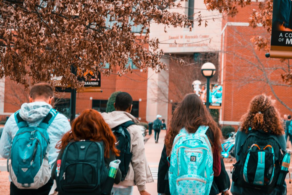 A group of students walking on a college campus